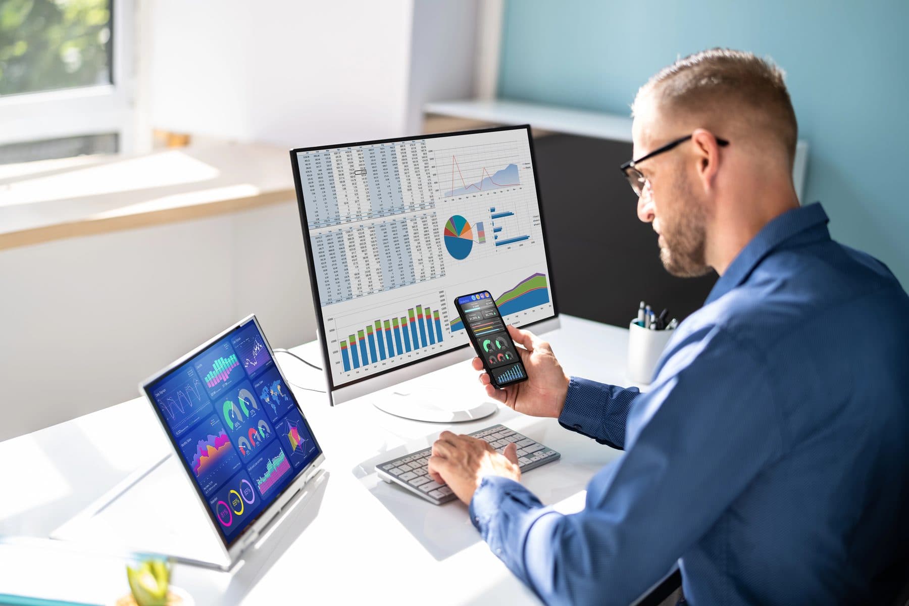 An IT professional reviewing security dashboards at a desk